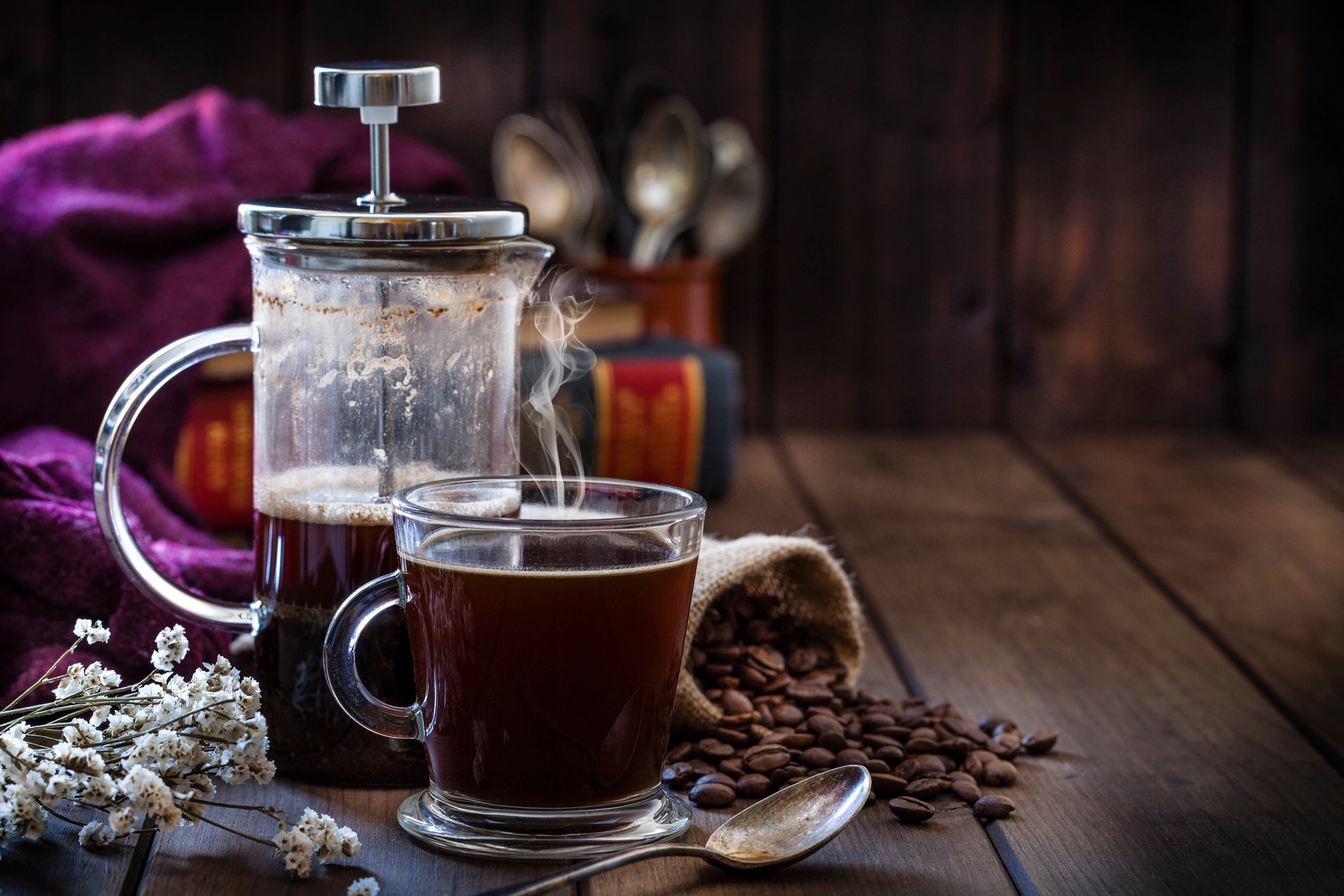 French press and coffee cup on a rustic wooden table