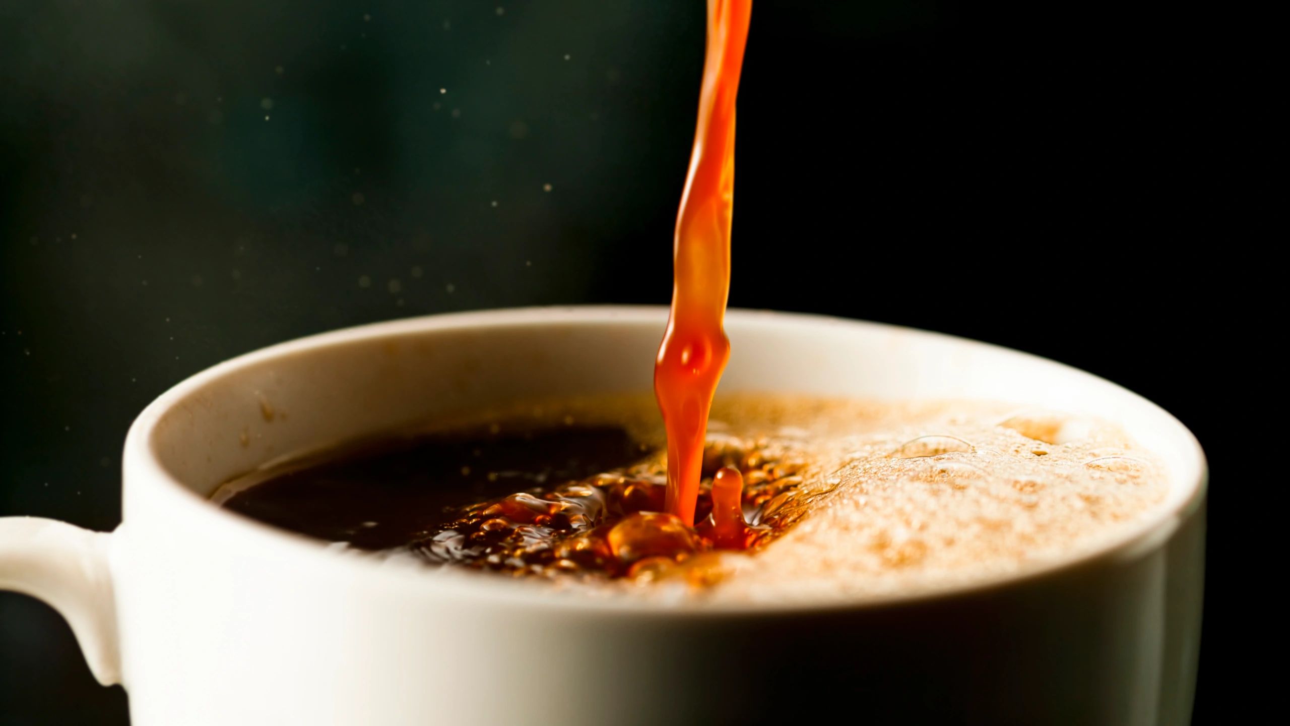 Fresh coffee being poured into a cup