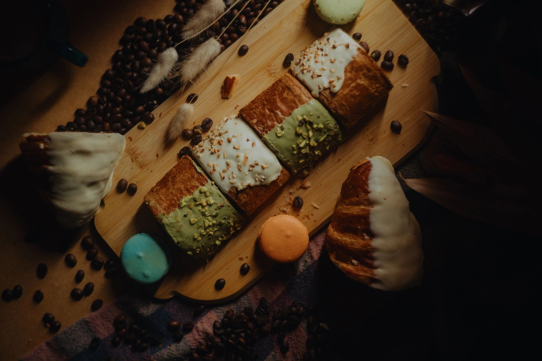 Pastries with coffee beans on a wooden board