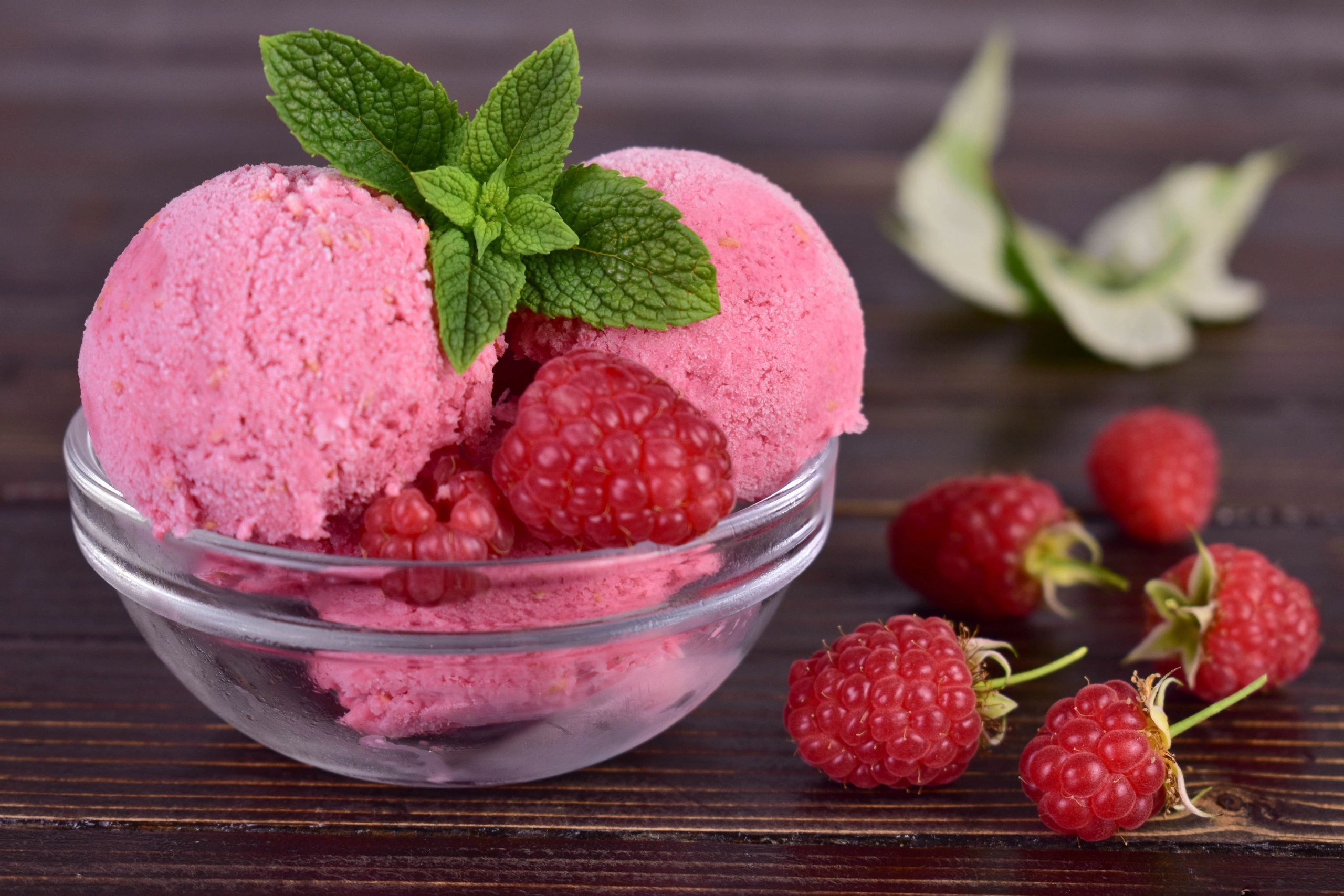 Homemade raspberry ice cream in a glass bowl